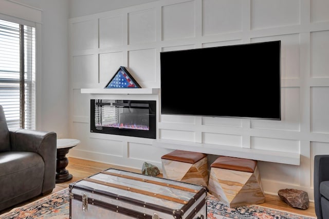 175 Dobson Knob Trl, Nolensville, TN 37135 - living room featuring a glass covered fireplace, light wood-style floors, and a decorative wall