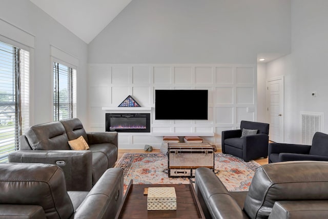 175 Dobson Knob Trl, Nolensville, TN 37135 - living room with dark wood finished floors, a glass covered fireplace, and high vaulted ceiling
