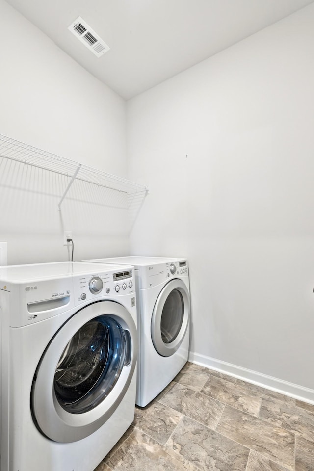 207 Addison Ave, Chapel Hill, TN 37034 - washroom with washing machine and dryer, baseboards, and light stone finish flooring
