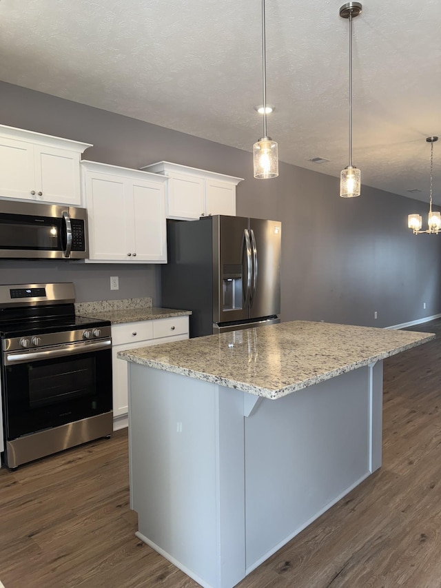 412 Moshe Mualem Pl, La Vergne, TN 37086 - kitchen with appliances with stainless steel finishes, dark wood finished floors, a center island, and white cabinetry