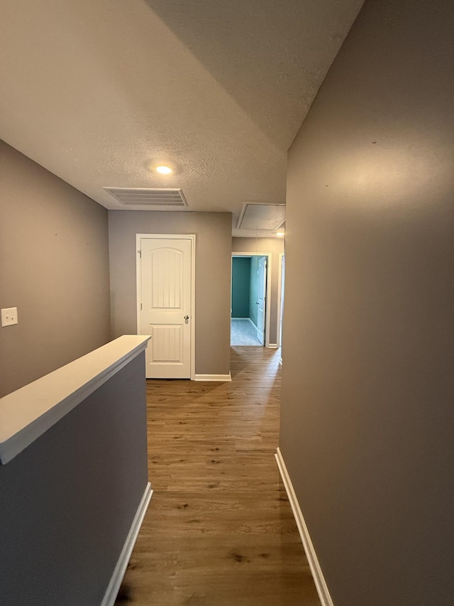 412 Moshe Mualem Pl, La Vergne, TN 37086 - hallway featuring attic access, wood finished floors, baseboards, and a textured ceiling