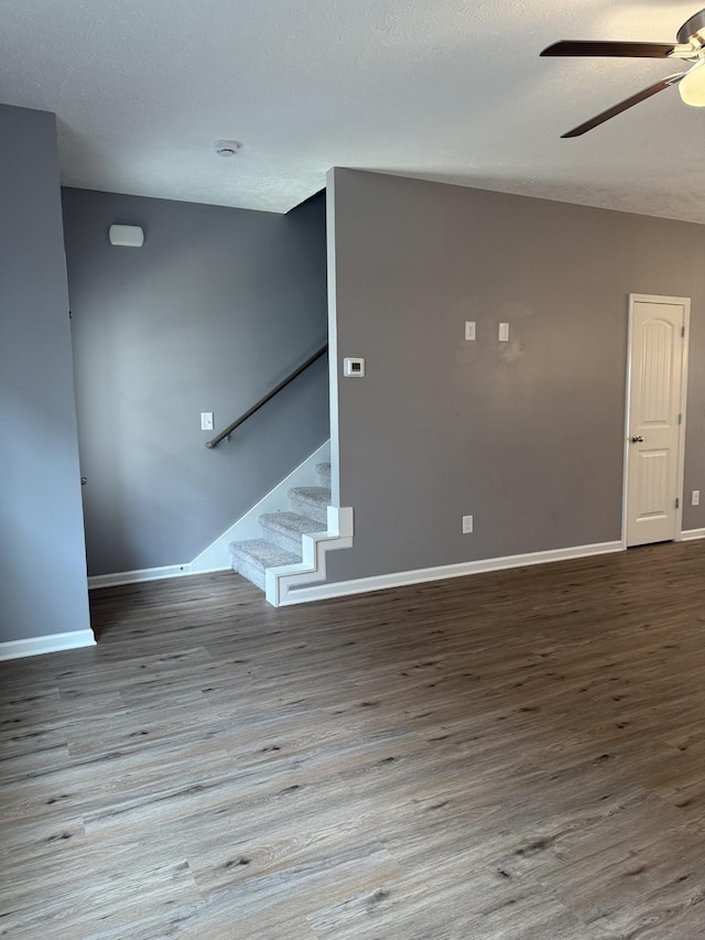 412 Moshe Mualem Pl, La Vergne, TN 37086 - unfurnished living room featuring a ceiling fan, wood finished floors, baseboards, and stairway