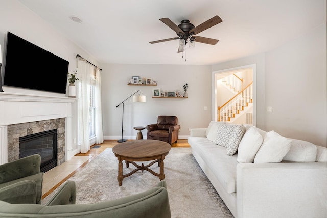 113 Joshuas Run, Goodlettsville, TN 37072 - living area with stairway, a ceiling fan, a tiled fireplace, and baseboards