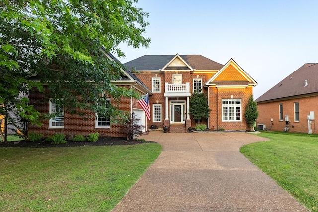 113 Joshuas Run, Goodlettsville, TN 37072 - georgian-style home featuring concrete driveway, brick siding, central air condition unit, and a front lawn