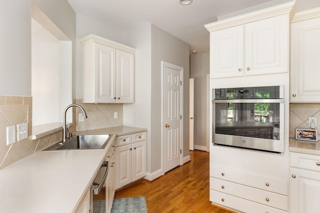 113 Joshuas Run, Goodlettsville, TN 37072 - kitchen with oven, a sink, light wood finished floors, tasteful backsplash, and light countertops