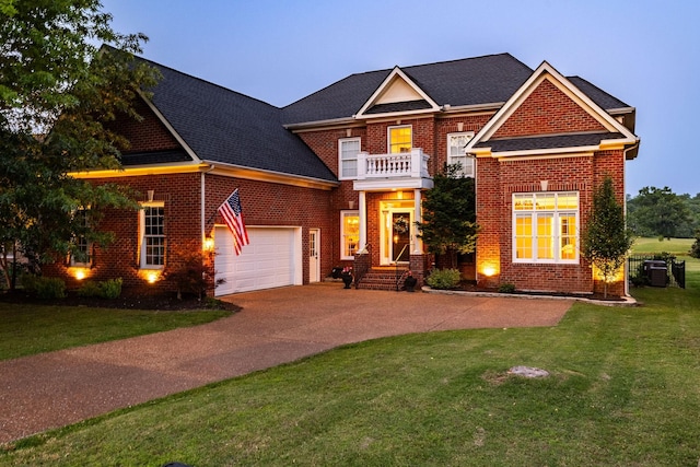 113 Joshuas Run, Goodlettsville, TN 37072 - colonial-style house featuring brick siding, concrete driveway, a front lawn, an attached garage, and a balcony