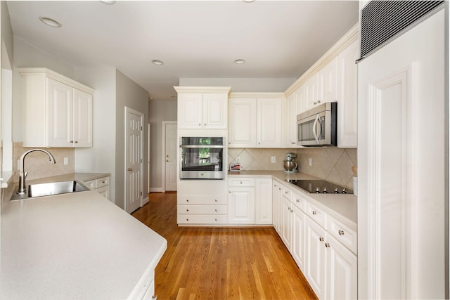 113 Joshuas Run, Goodlettsville, TN 37072 - kitchen with stainless steel appliances, a sink, light wood-type flooring, decorative backsplash, and recessed lighting
