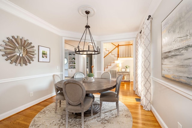 113 Joshuas Run, Goodlettsville, TN 37072 - dining room featuring stairway, crown molding, a chandelier, light wood finished floors, and baseboards