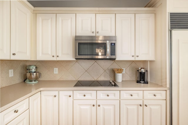 113 Joshuas Run, Goodlettsville, TN 37072 - kitchen featuring stainless steel microwave, black electric stovetop, decorative backsplash, and light countertops