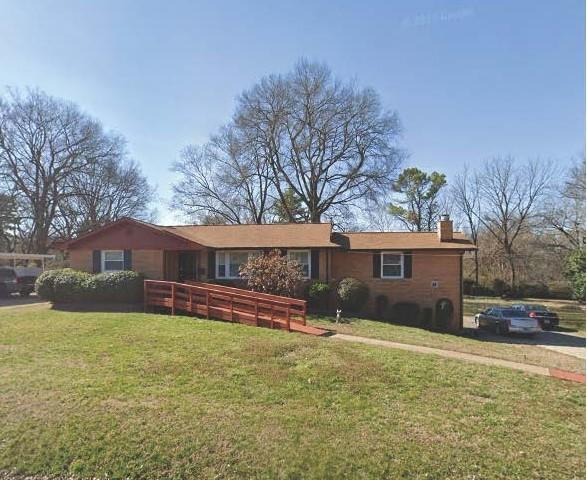 712 Robert Burns Dr, Nashville, TN 37217 - ranch-style house with a front yard and a chimney