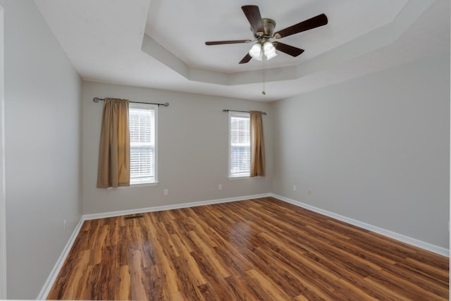 55 Bluebird Ln, Lafayette, TN 37083 - spare room featuring wood finished floors, a tray ceiling, baseboards, and a ceiling fan
