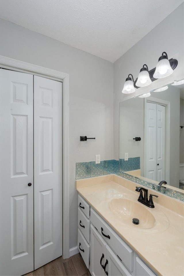 55 Bluebird Ln, Lafayette, TN 37083 - bathroom featuring a closet, vanity, and wood finished floors