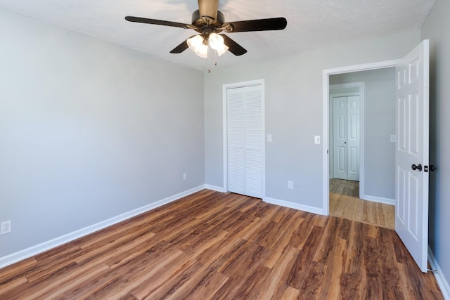 55 Bluebird Ln, Lafayette, TN 37083 - unfurnished bedroom featuring wood finished floors, baseboards, a closet, and a ceiling fan