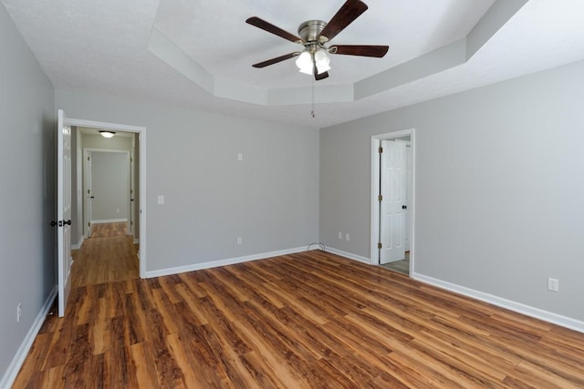 55 Bluebird Ln, Lafayette, TN 37083 - unfurnished room with wood finished floors, ceiling fan, baseboards, and a raised ceiling