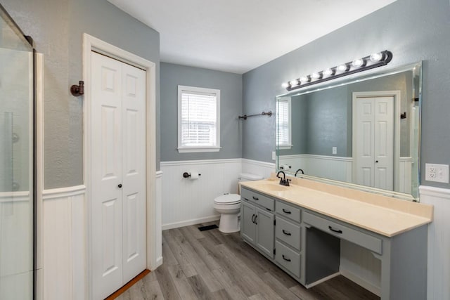 55 Bluebird Ln, Lafayette, TN 37083 - bathroom featuring a closet, wainscoting, vanity, wood finished floors, and toilet