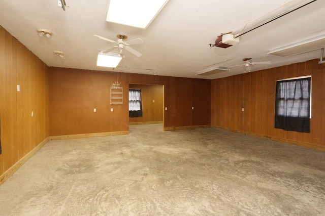 55 Bluebird Ln, Lafayette, TN 37083 - empty room featuring ceiling fan, concrete flooring, and wood walls