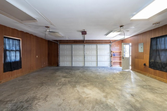 55 Bluebird Ln, Lafayette, TN 37083 - garage with wood walls, electric panel, ceiling fan, and a garage door opener