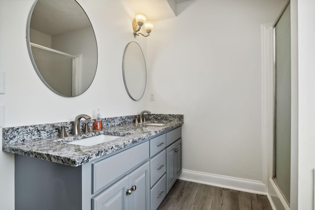 2056 Earl Pearce Cir, Mount Juliet, TN 37122 - bathroom with wood finished floors, double vanity, baseboards, and a shower with shower door