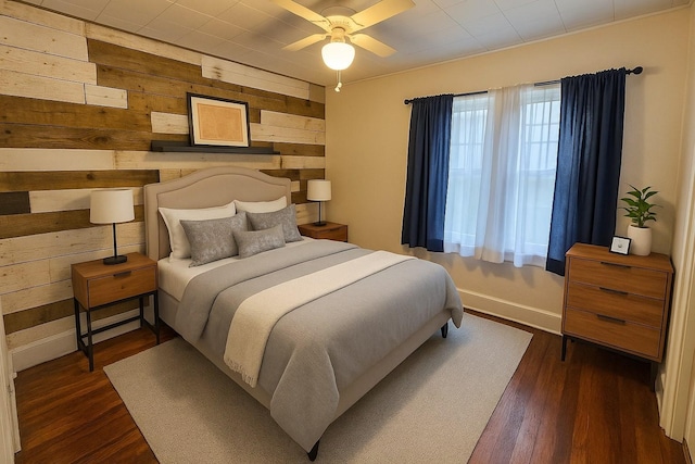 1105 Normandy Rd, Normandy, TN 37360 - bedroom featuring wood walls, dark wood finished floors, and baseboards