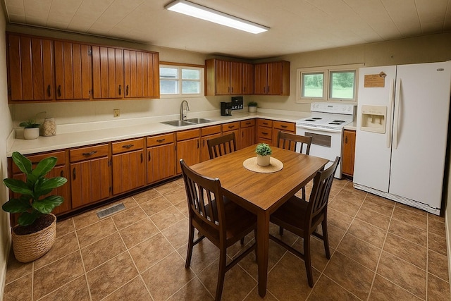 1105 Normandy Rd, Normandy, TN 37360 - kitchen featuring white appliances, a sink, light countertops, and brown cabinetry