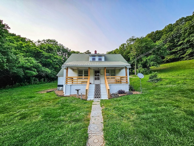 1105 Normandy Rd, Normandy, TN 37360 - bungalow-style house with a porch, a front yard, metal roof, a chimney, and stairway