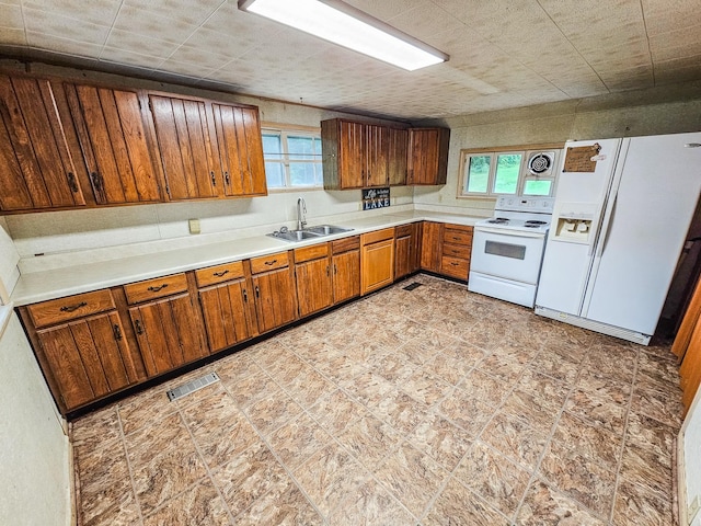 1105 Normandy Rd, Normandy, TN 37360 - kitchen with white appliances, a sink, brown cabinetry, and light countertops