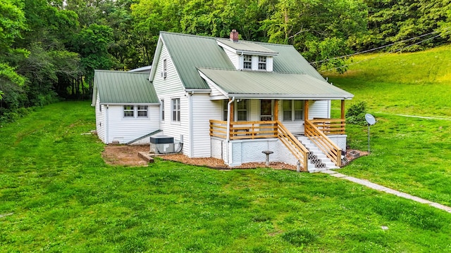 1105 Normandy Rd, Normandy, TN 37360 - view of front of home featuring covered porch, central AC unit, a front lawn, metal roof, and a chimney