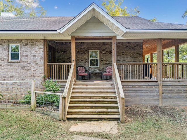 1064 Bills Ln, Joelton, TN 37080 - doorway to property featuring brick siding, a shingled roof, and covered porch