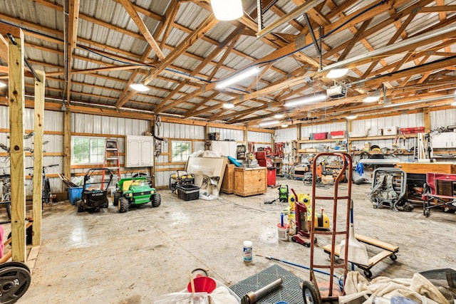 1064 Bills Ln, Joelton, TN 37080 - garage with a workshop area, metal wall, and a garage door opener