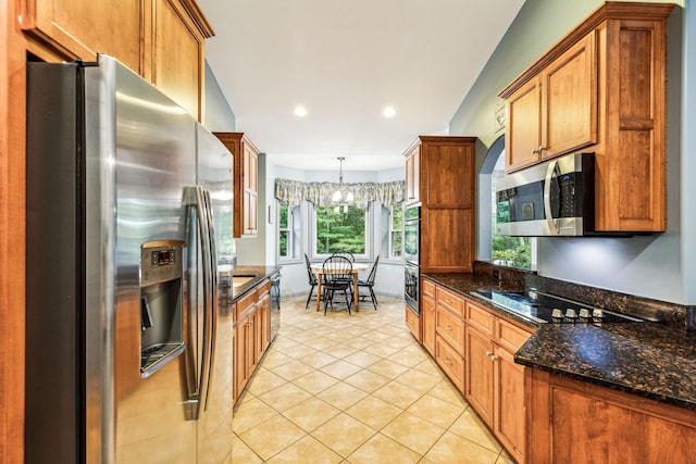 1064 Bills Ln, Joelton, TN 37080 - kitchen with stainless steel appliances, light tile patterned flooring, brown cabinets, dark stone countertops, and pendant lighting