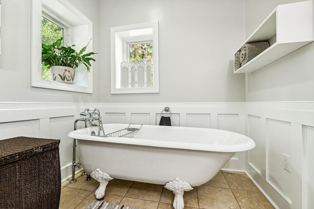 1064 Bills Ln, Joelton, TN 37080 - full bath featuring plenty of natural light, a freestanding tub, tile patterned flooring, wainscoting, and a decorative wall