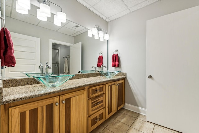 1064 Bills Ln, Joelton, TN 37080 - bathroom featuring a paneled ceiling, tile patterned floors, double vanity, and baseboards