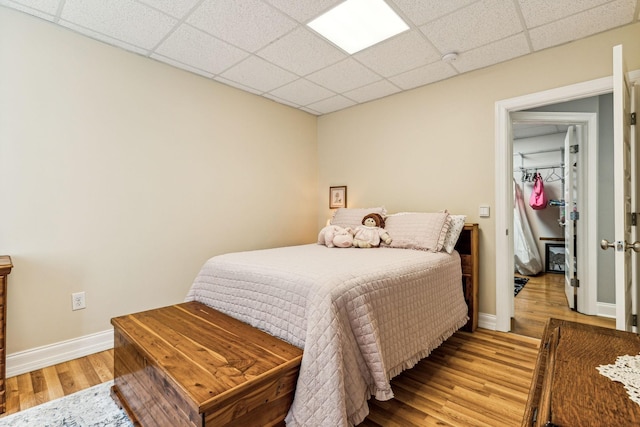 1064 Bills Ln, Joelton, TN 37080 - bedroom featuring light wood finished floors, a paneled ceiling, and baseboards