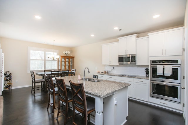 8023 Forest Hills Dr, Spring Hill, TN 37174 - kitchen featuring a sink, appliances with stainless steel finishes, dark wood-style flooring, an island with sink, and recessed lighting