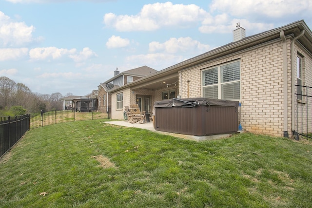 8023 Forest Hills Dr, Spring Hill, TN 37174 - back of property featuring a hot tub, brick siding, a chimney, and a patio