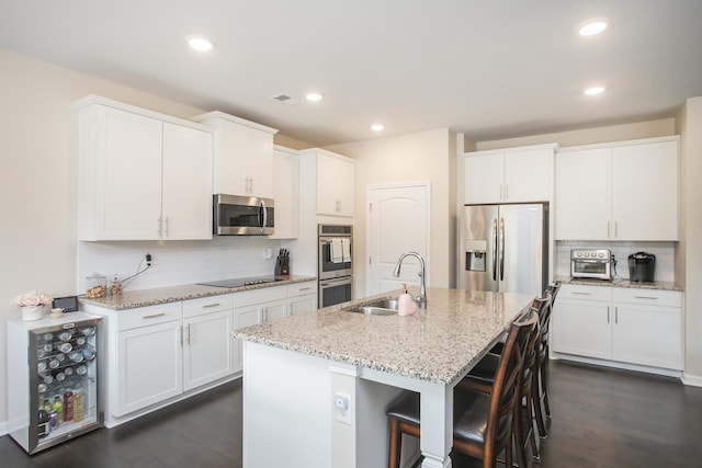 8023 Forest Hills Dr, Spring Hill, TN 37174 - kitchen with a sink, appliances with stainless steel finishes, dark wood finished floors, backsplash, and recessed lighting