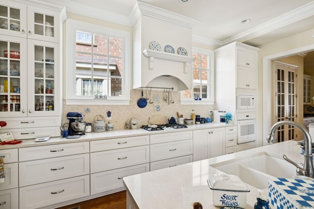 3007 General Martin Ln, Franklin, TN 37064 - kitchen featuring white appliances, a sink, white cabinetry, light countertops, and ornamental molding