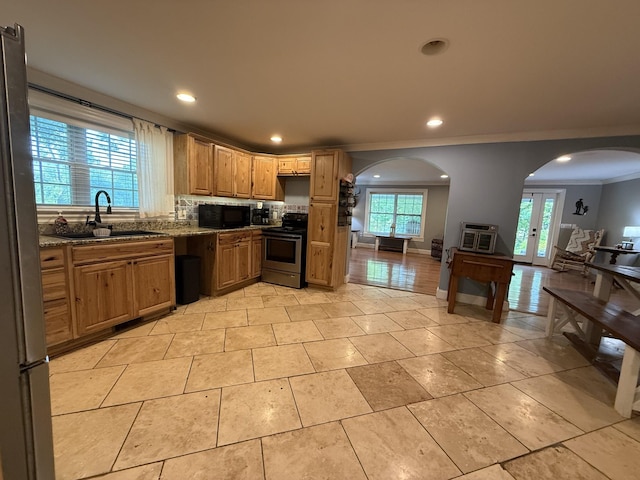 1650 E Beaverdam Rd, Centerville, TN 37033 - kitchen with stainless steel appliances, a sink, ornamental molding, stone countertops, and arched walkways