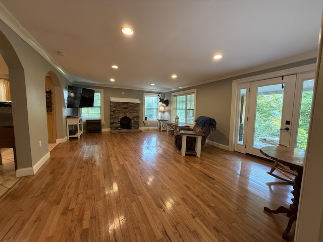 1650 E Beaverdam Rd, Centerville, TN 37033 - living area with ornamental molding, arched walkways, a fireplace, baseboards, and wood finished floors