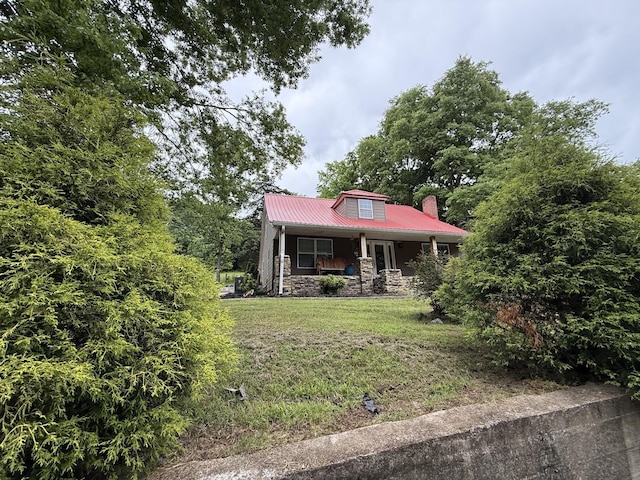 1650 E Beaverdam Rd, Centerville, TN 37033 - view of front of property with a porch, metal roof, a front yard, a chimney, and stone siding