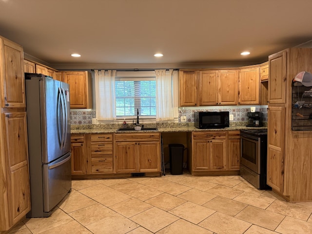 1650 E Beaverdam Rd, Centerville, TN 37033 - kitchen with stainless steel appliances, a sink, decorative backsplash, dark stone counters, and recessed lighting