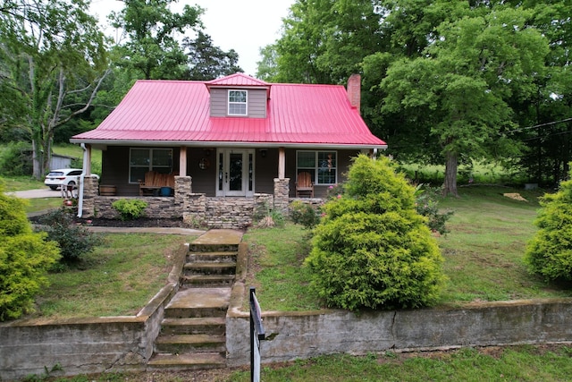 1650 E Beaverdam Rd, Centerville, TN 37033 - view of front facade with covered porch, metal roof, a chimney, and stone siding