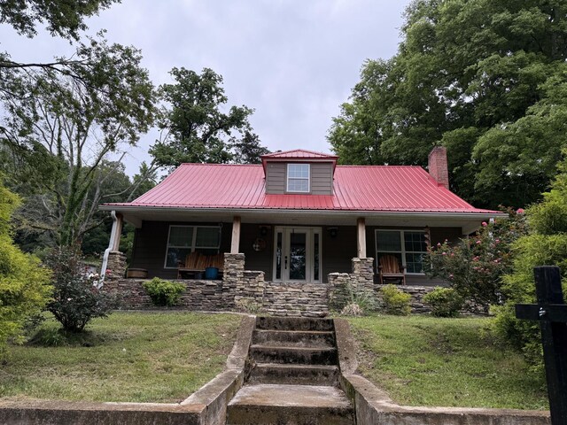 1650 E Beaverdam Rd, Centerville, TN 37033 - view of front of house featuring metal roof, a front lawn, covered porch, and a chimney