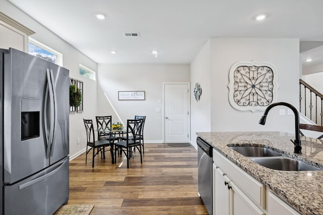 1045 Brayden Dr, Fairview, TN 37062 - kitchen featuring stainless steel appliances, a sink, white cabinetry, dark wood finished floors, and recessed lighting