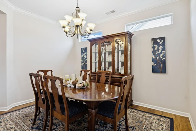 1045 Brayden Dr, Fairview, TN 37062 - dining area featuring a chandelier, baseboards, crown molding, and wood finished floors