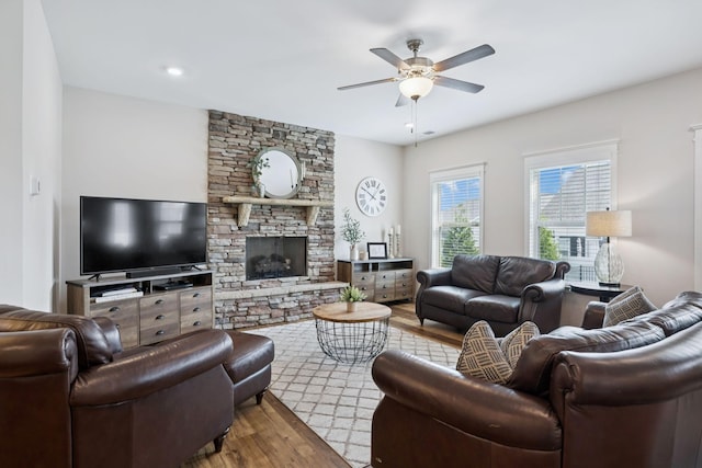 1045 Brayden Dr, Fairview, TN 37062 - living area featuring wood finished floors, ceiling fan, and a stone fireplace