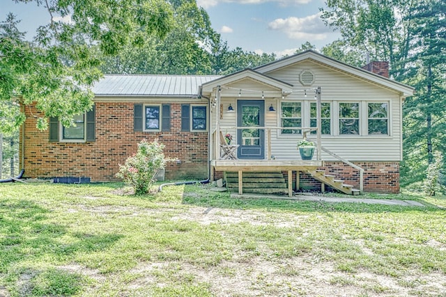 260 Fate Ivy Rd, Monterey, TN 38574 - view of front of property with a front yard, a chimney, brick siding, and metal roof