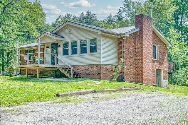 260 Fate Ivy Rd, Monterey, TN 38574 - view of front of house featuring a front yard, a chimney, and brick siding