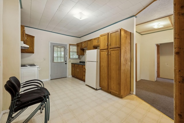 1319 Main St N, Carthage, TN 37030 - kitchen with white appliances, brown cabinets, under cabinet range hood, and light flooring