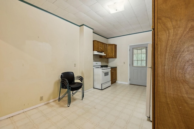 1319 Main St N, Carthage, TN 37030 - kitchen featuring white range with electric cooktop, under cabinet range hood, light flooring, brown cabinets, and baseboards